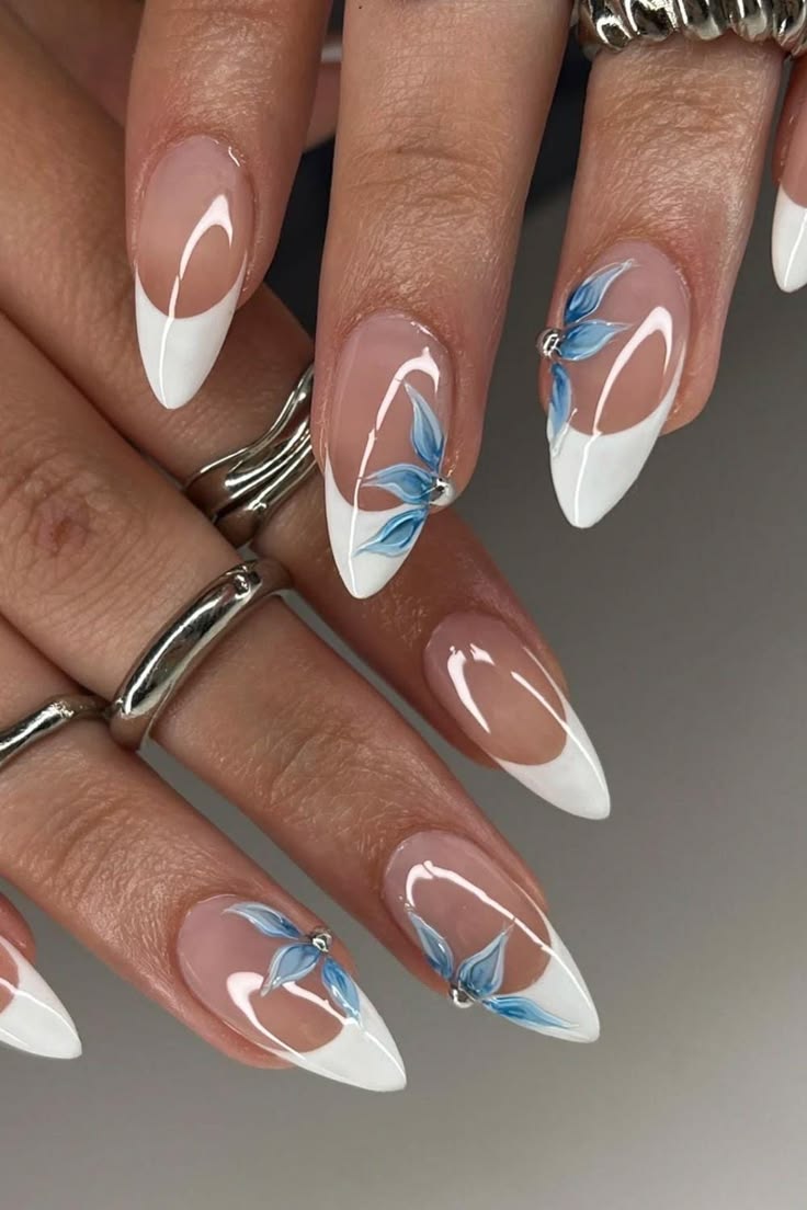White French almond nails with blue 3D flower detail